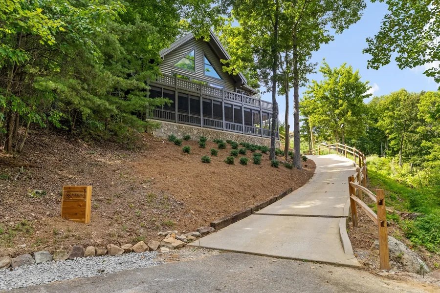 The house seen from the path below, porches stacked above the trees