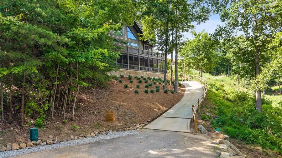 New concrete walkway curving up the hillside to the house