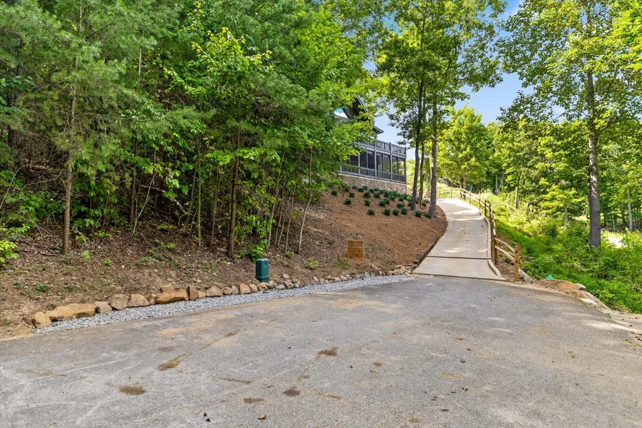 Concrete parking pad and the start of the walkway up to the house