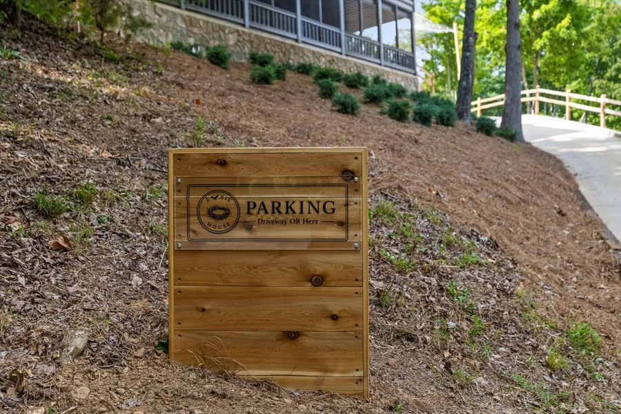 Cedar parking sign on the hillside below the house