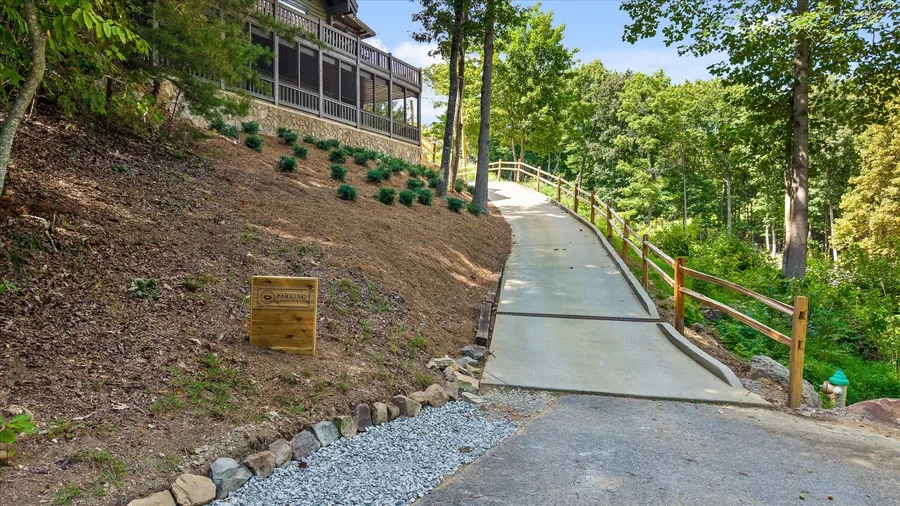 Walkway and handrail running along the planted hillside to the house