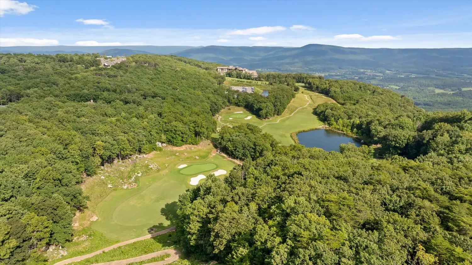 Aerial view of McLemore looking across the golf course toward the pro shop, the Cloudland hotel further along the ridge, with The Eyrie House in the trees below the course