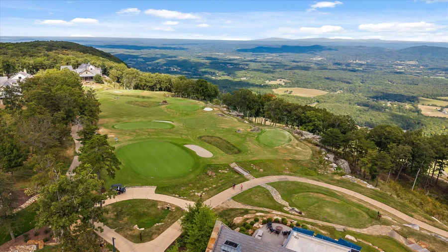 Aerial view of the short course in the foreground with the eighteenth green and Lookout Mountain running out beyond