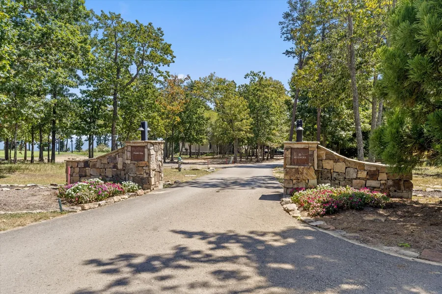 Stone entry gates and the road running into the resort
