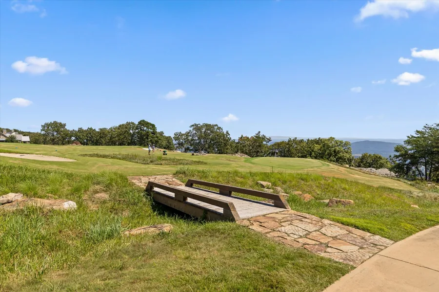 Stone-walled tee box built into the slope on the short course