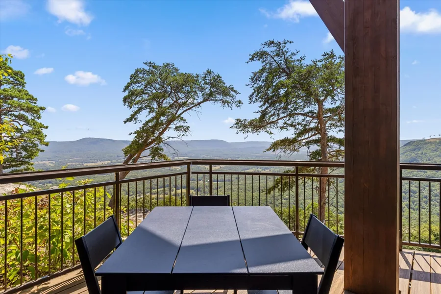 Covered terrace table at Skyside looking out over the trees and the valley